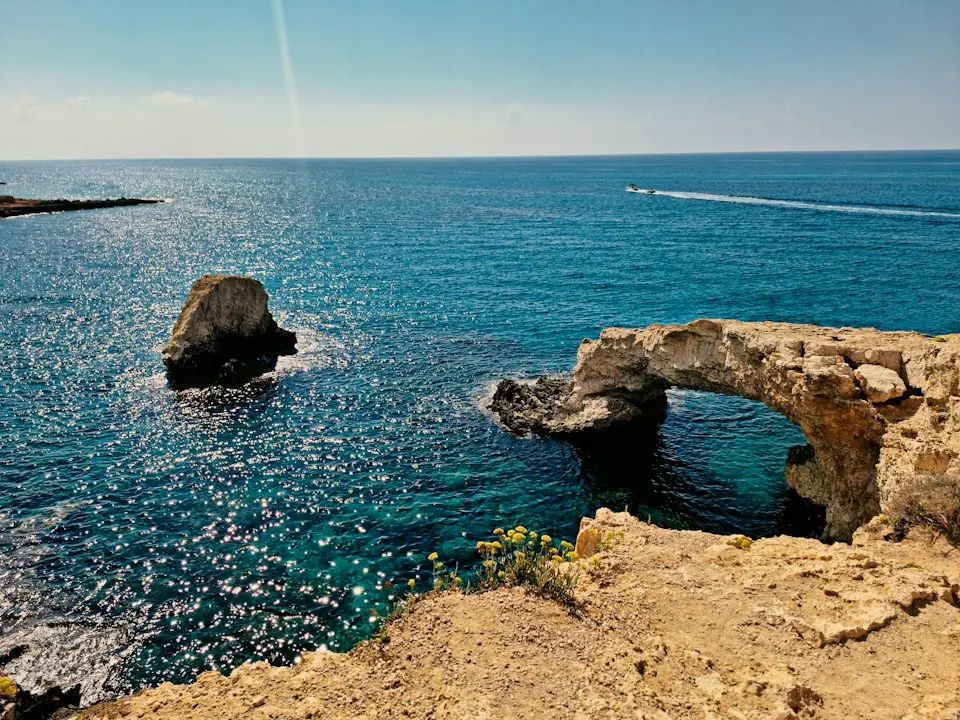 The Lovers' Bridge, a natural rock arch over clear blue sea on the Ayia Napa coast