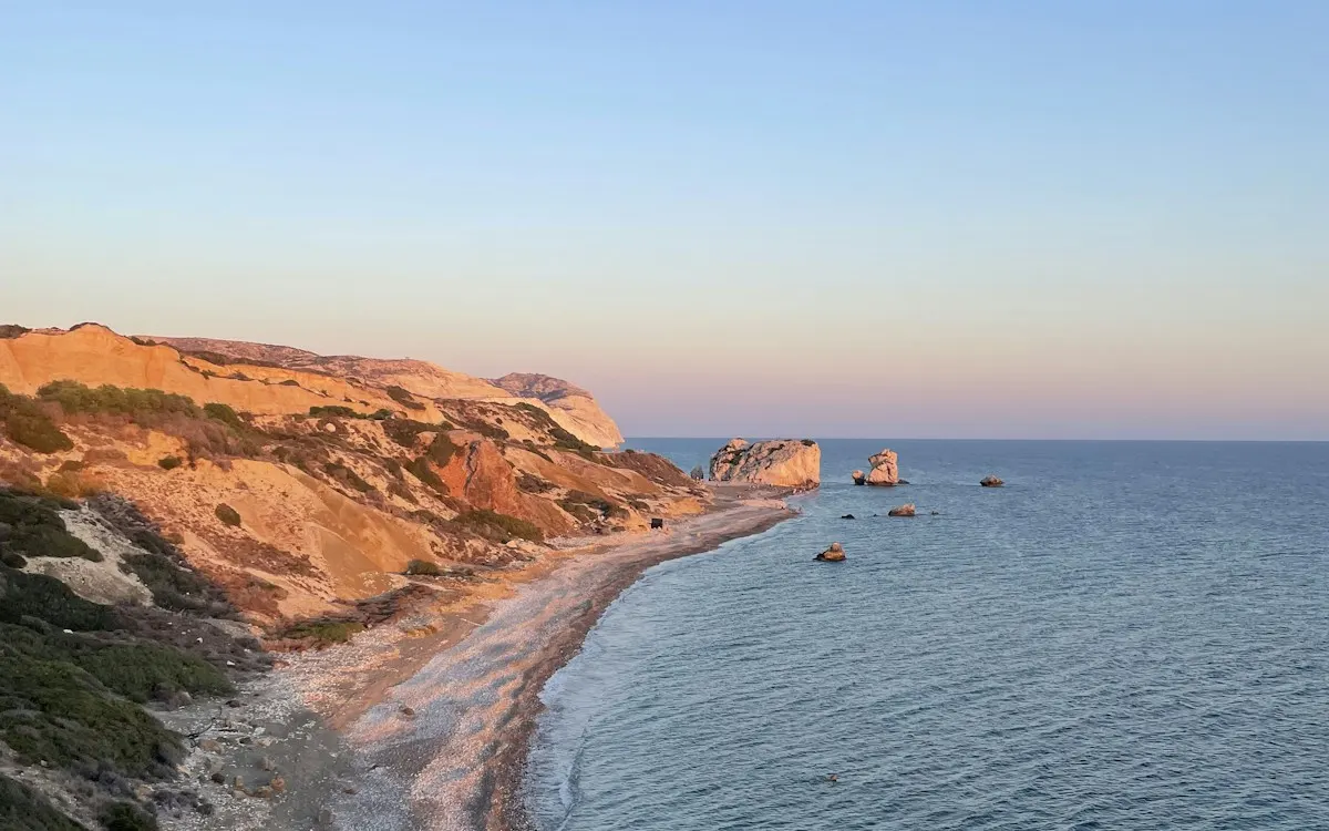 Evening light on the cliffs and a long pebble beach on the Cyprus coast