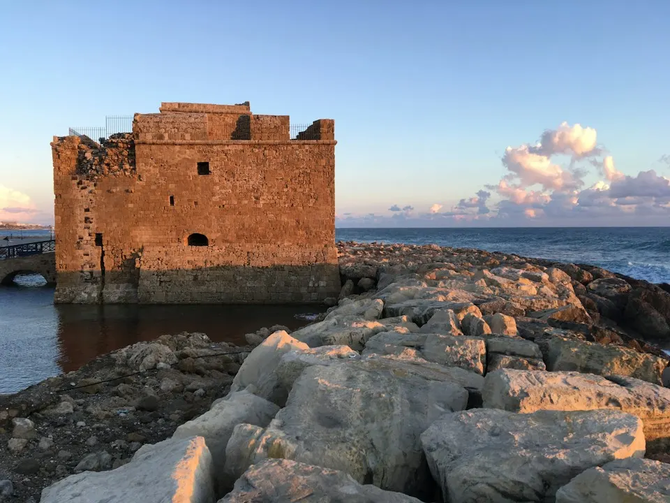 Paphos harbour castle on its rocky breakwater in late-afternoon light